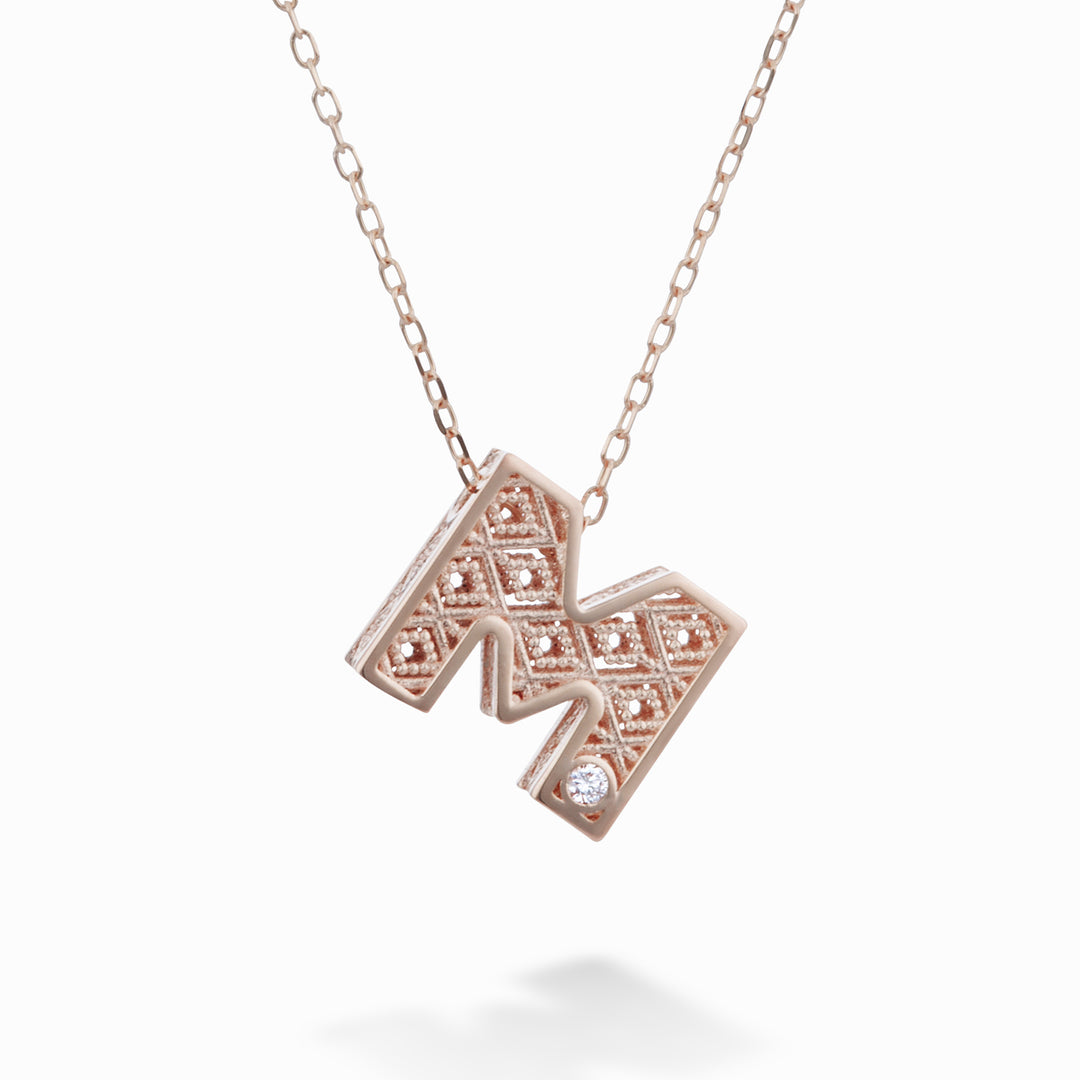 Nihama cl 18k lettera m oro rosè diam. ct.0,01 NDLETMO3